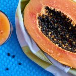 Papaya cut in half and a drink.