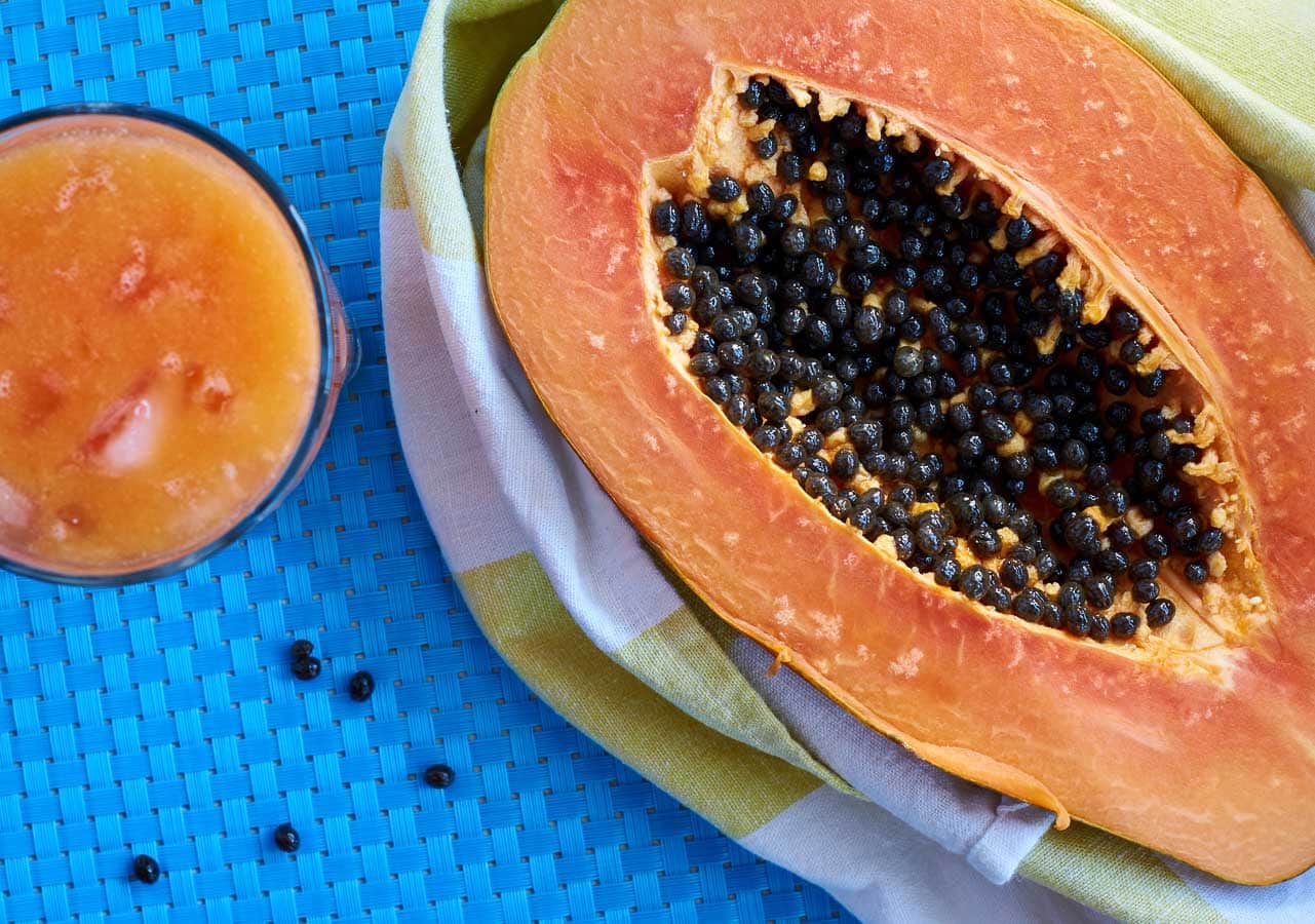 Papaya cut in half and a drink.