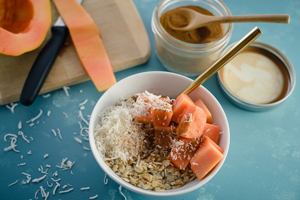 Oatmeal breakfast with papaya and coconut.