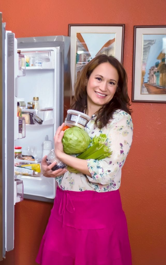 Malena in front of the refrigerator with vegetables
